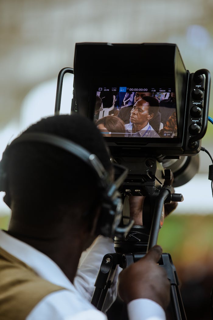 Cameraman films an event in Dar es Salaam using professional equipment.